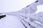 Fence Is Covered By Snow And Spruce Pattern In Winter Stock Photo