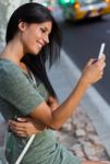 Beautiful Woman Use Her Phone In The City At Night Stock Photo