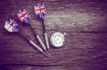 Darts And Watch On Old Wooden Background. Vintage Style Stock Photo