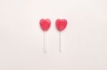 Two Pink Valentine's Day Heart Shape Lollipop Candy On Empty White Paper Background. Love Concept. Knolling Top View. Minimalism Colorful Hipster Style Stock Photo