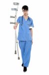 Sad Doctor Holding Up Crutches In Hand Stock Photo