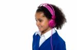 Charming Young Kid Listening To Music Stock Photo