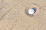 Golf Ball In Sand Bunker Stock Photo