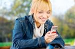 Woman At Park Taking A Phone Call Stock Photo