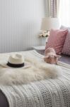 Pink Pillows With Pink Doll On White Wooden Bed And Classic Hat Stock Photo