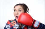 Asian Woman With Red Boxing Glove Punch Her Face Stock Photo