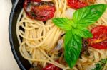 Spaghetti Pasta With Baked Cherry Tomatoes And Basil Stock Photo