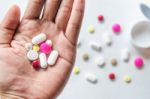 Top View Of The Pills On The Hand And White Background, A Hand Hold The Pills And Drug Stock Photo