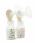 Twin Breast Pump And Milk Bottles On White Background Stock Photo