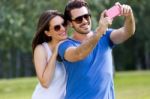 Happy Young Couple Taking Selfies With Her Smartphone In The Par Stock Photo