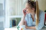 Young Beautiful Woman Using Her Mobile Phone At Home Stock Photo