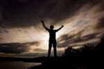 Silhouette Tourist Man Open Arm. He Is Happy In The Mountain. To Stock Photo