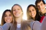 A Group Of Friends Taking Photos With A Smartphone Stock Photo