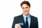 Cheerful Businessman Holding Credit Card Stock Photo