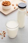 Almond Milk In Glass And Bottle With Almonds On Table Stock Photo