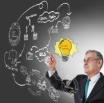 Businessman With Idea Lightbulb Stock Photo