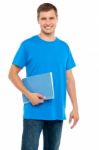 Smiling Man Holding Spiral Notebook Stock Photo