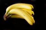 Bananas On Black Stock Photo