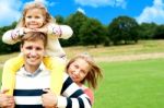 Smiling Family Enjoying In Outdoors Stock Photo