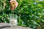 Man Pouring Beer From A Jar Into A Mug Stock Photo