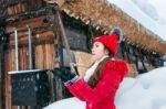 Young Woman In Shirakawa-go Village In Winter, Unesco World Heritage Sites, Japan Stock Photo