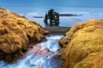 Waterfall And Hvitserkur Is Spectacular Rock In The Sea On The Northern Coast Of Iceland Stock Photo