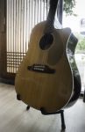 Acoustic Guitar Resting Against Mirror Background Stock Photo