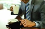 Professional Using A Tablet Computer At Cafe Stock Photo