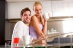 Couple In Kitchen Having Breakfast Stock Photo