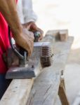 Carpenter Working With Electric Planer Stock Photo