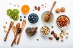 Ingredients For A Healthy Foods Background, Nuts, Honey, Berries Stock Photo