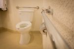 Disabled Toilet Bathroom With Grab Bars In White Interior Design Hotel Stock Photo