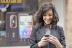 Lady Reading Sms In Street Stock Photo