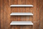 Three White Shelves On Wooden Interior Texture Background Stock Photo