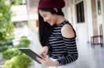 Portrait Of Thai Teen Beautiful Girl Using Her Tablet Stock Photo