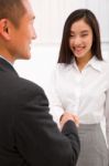 Businesswoman Shaking Hand With Businessman Stock Photo