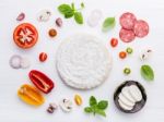 The Ingredients For Homemade Pizza On White Wooden Background Stock Photo