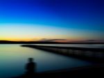 Horizontal Vivid Man's Back Shadow Sitting On The Quay Motion Ab Stock Photo