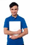 Young Smiling Guy Holding Laptop Stock Photo