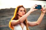 Girl With Smart Phone Near Beach Stock Photo