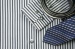 Tie And Belt On Striped Shirt Background Stock Photo