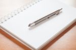 Pen On Open Blank White Notebook On The Desk Stock Photo