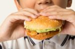 Boy Eating A Burger Stock Photo