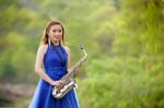 Beautiful Woman Wear Blue Evening Dress Holding Saxophone Stand Stock Photo