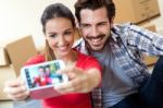 Young Couple  Taking Selfies In Their New Home Stock Photo