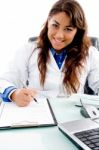 Smiling Doctor Writing Prescription Stock Photo