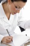 Female Doctor Writing on clipboard Stock Photo