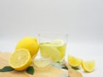 Fresh Lemon In Water, Lemonade And Lemon Slice On White Wood Bac Stock Photo