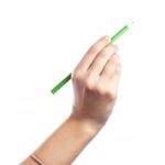 Colored Pencils In A Female Hand On A White Background  Stock Photo