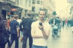 Young Man In City With Mobile Phone Stock Photo